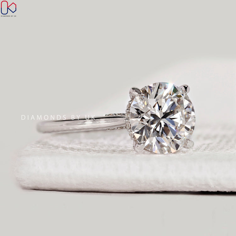 Handmade round engagement ring with bridge accent.