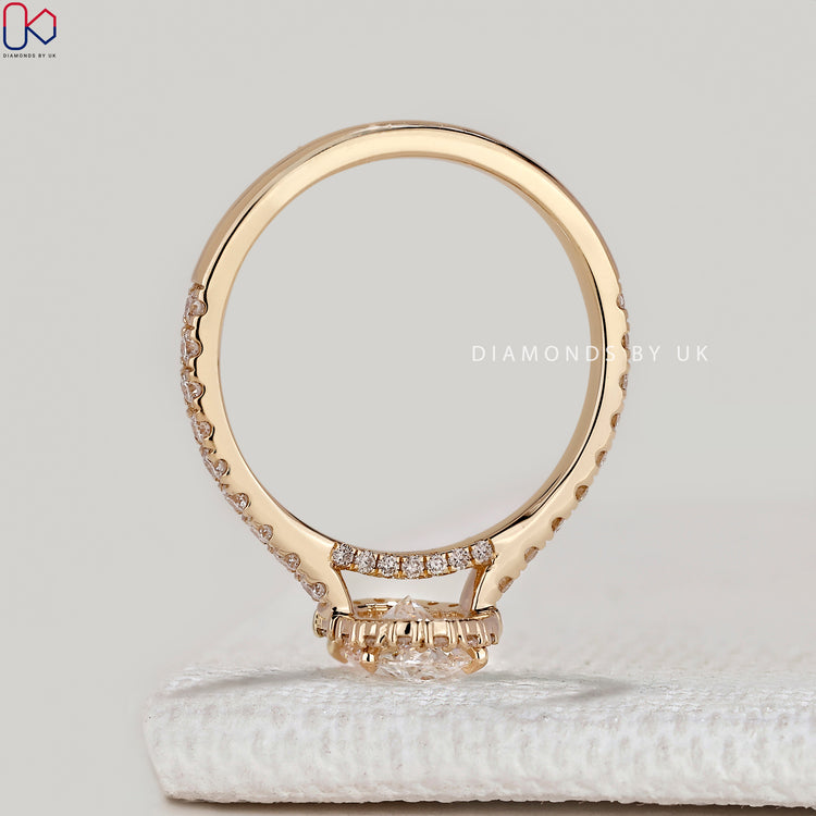 Oval ring with round and baguette diamond halo.