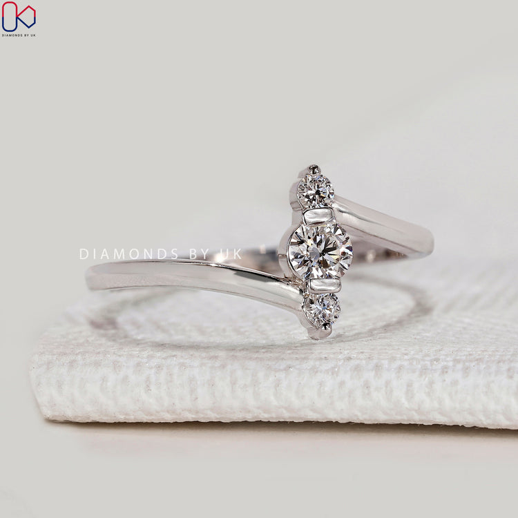 Lab grown three stone ring with bypass setting.
