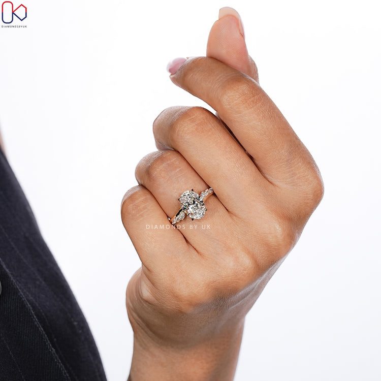 Handmade oval diamond ring with four claw prong setting.
