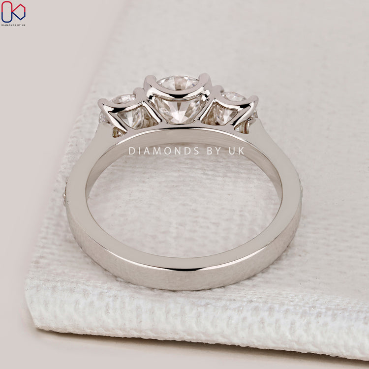IGI Certified round cut three stone diamond ring.