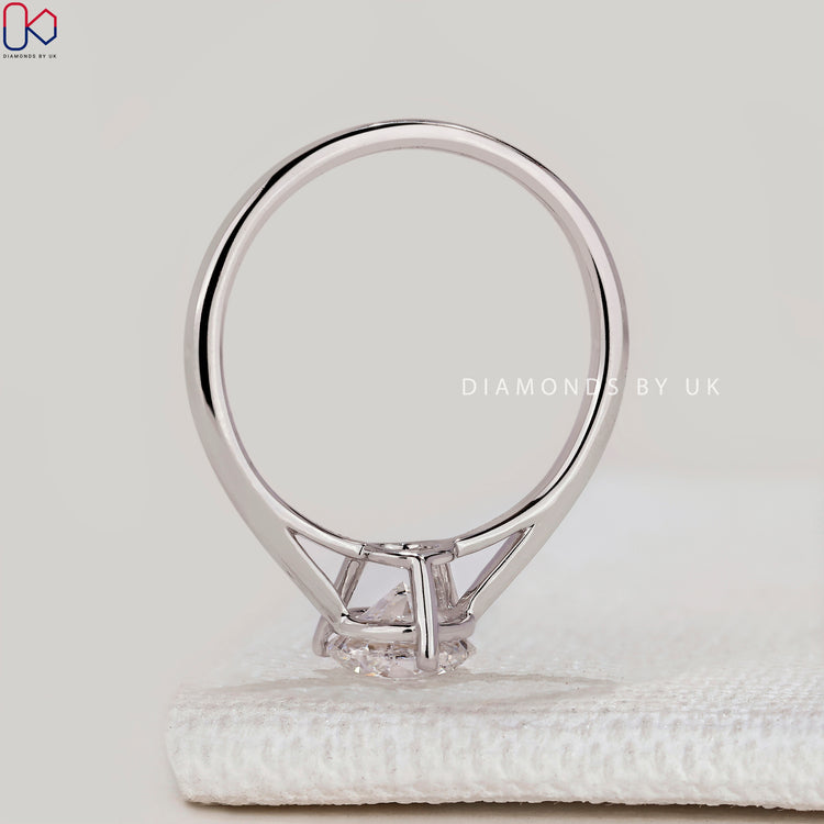 Round diamond ring with three prong cathedral setting.

