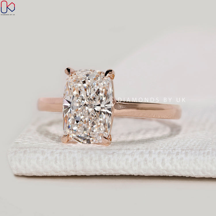Handmade cushion ring with four claw prong setting.