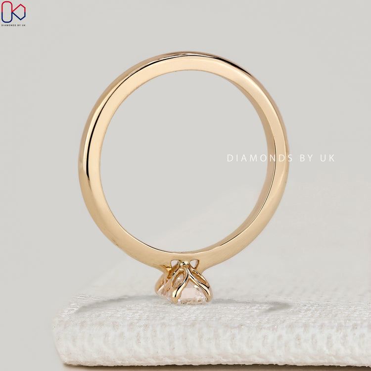 Emerald cut solitaire ring with cathedral setting.