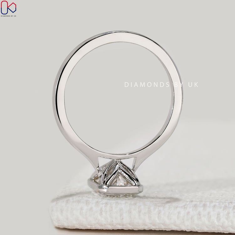 Radiant cut ring with cathedral and bezel setting.

