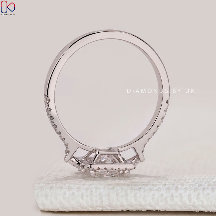 Princess ring with pear side stones and round pavé.
