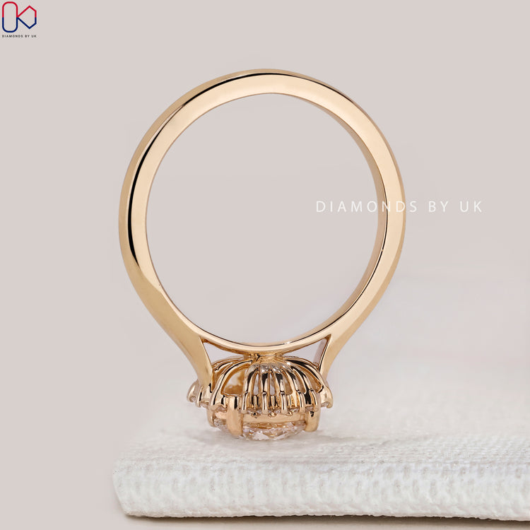 Round diamond ring with cluster halo setting.