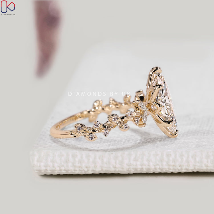 Lab grown marquise diamond ring with six claw prongs.
