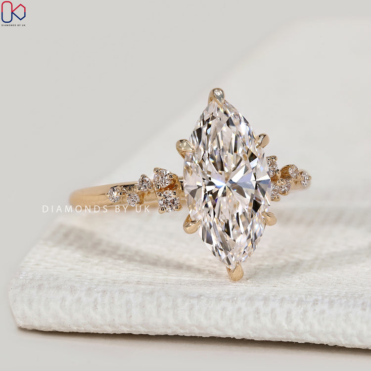Marquise cut lab grown diamond ring with cluster setting.