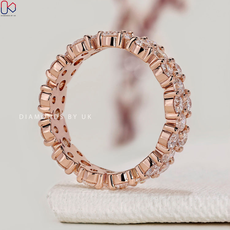 Handmade round diamond wedding band with clusters.
