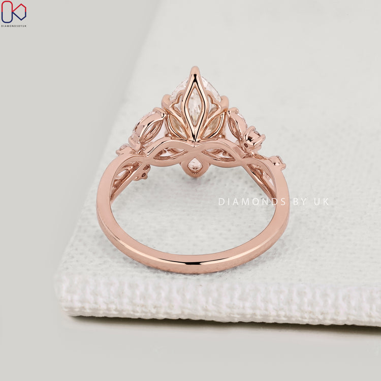 Lab grown marquise diamond ring with cluster side stones.
