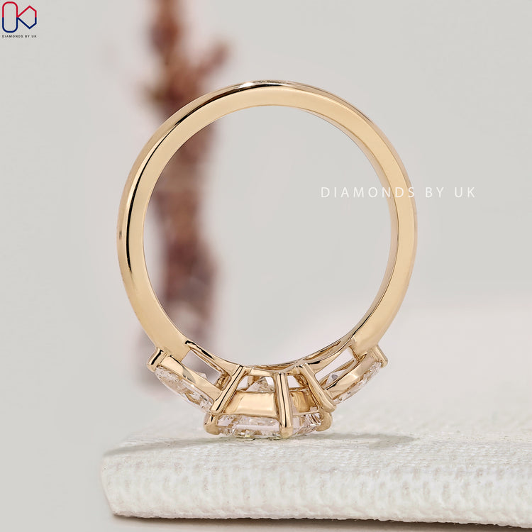 IGI certified princess diamond ring with pear side stone.
