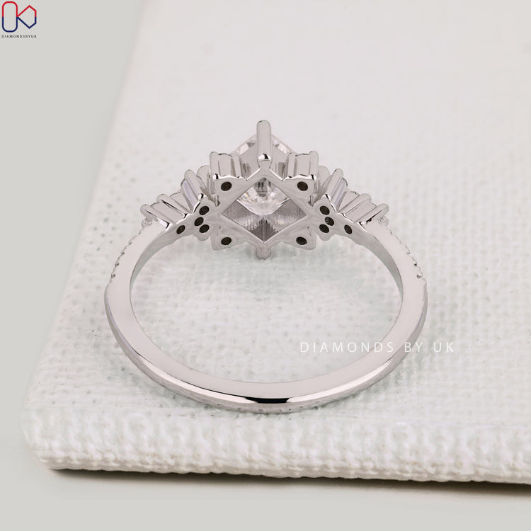 Handmade princess cut ring with round diamond pavé.
