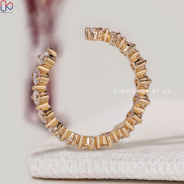 Open gap wedding band with round diamond setting.