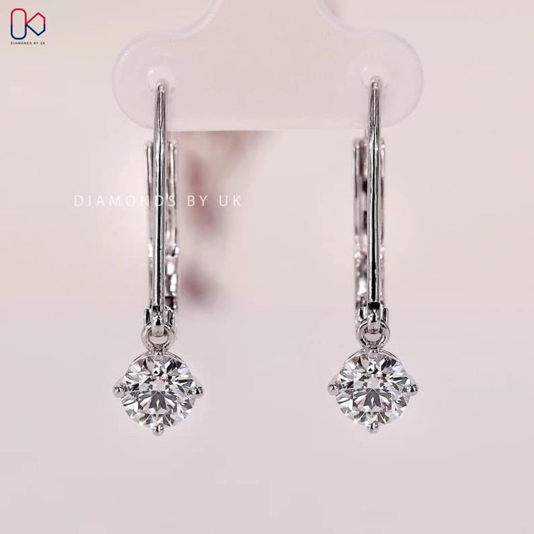 Lab grown round diamond earrings with compass prongs.