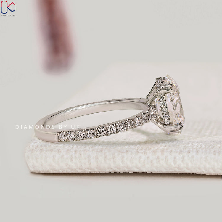 Lab grown oval diamond ring with double claw prongs.