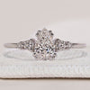 Pear cut ring with round side stones and muse setting.