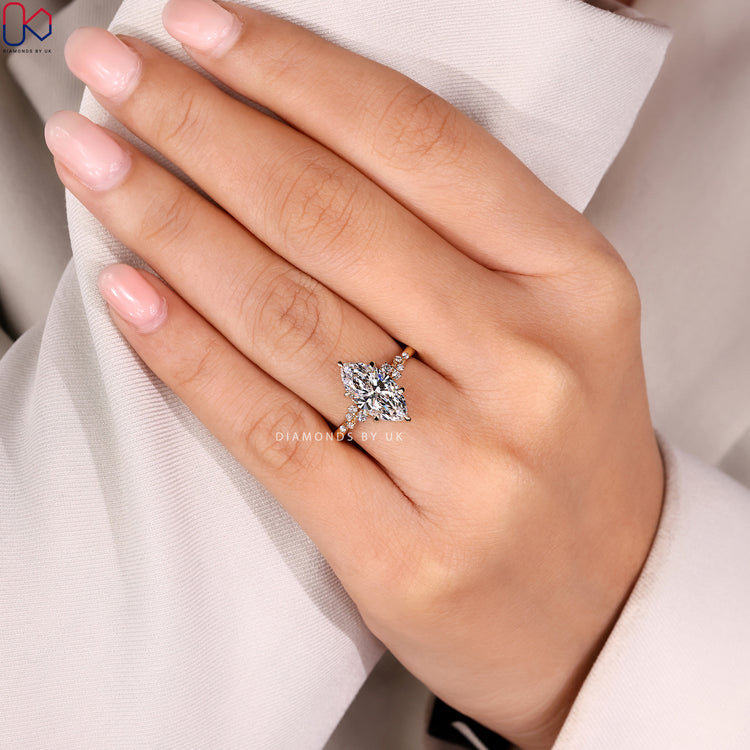 Marquise engagement ring with cluster diamond setting.