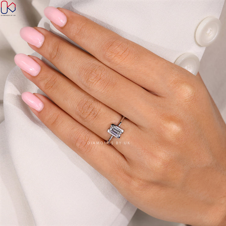 Emerald cut ring with secure half bezel setting.
