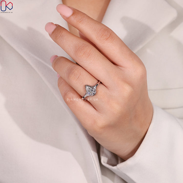 Lab grown pear ring with tapered shank design.

