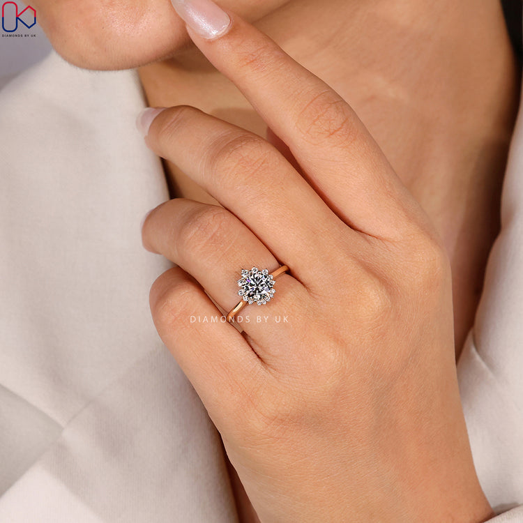 Four prong round diamond ring with cluster halo.
