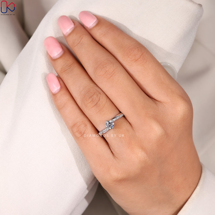 Round cut engagement ring with bypass design.