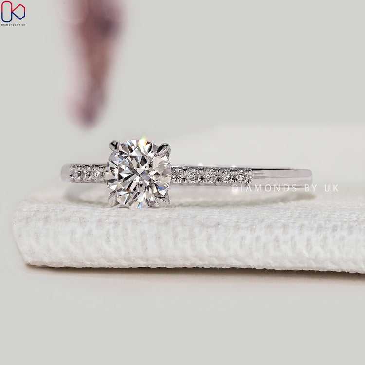Round cut diamond engagement ring with pavé style.