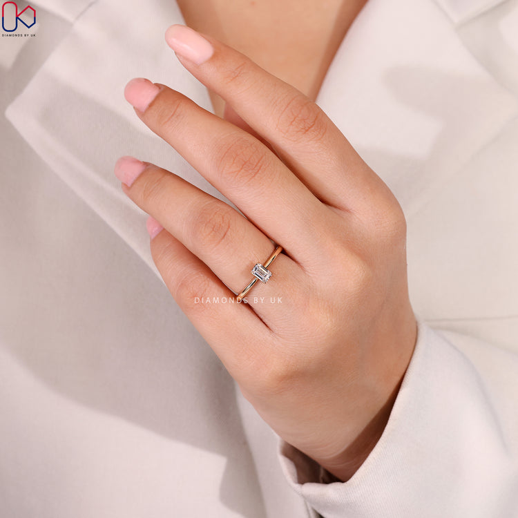 Emerald cut ring with tapered shank and prongs.