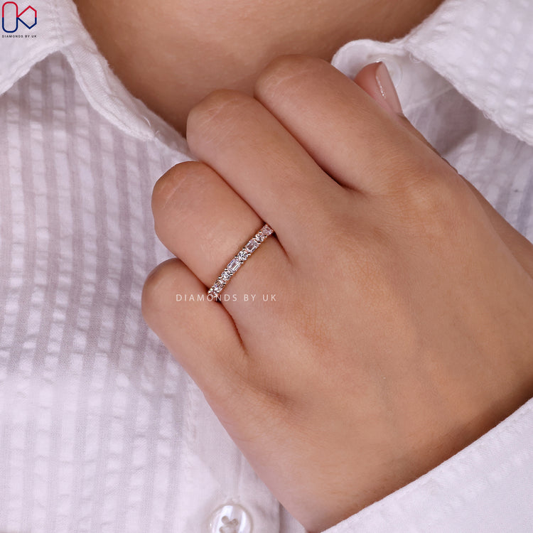 Handmade eternity band with emerald and round diamonds.
