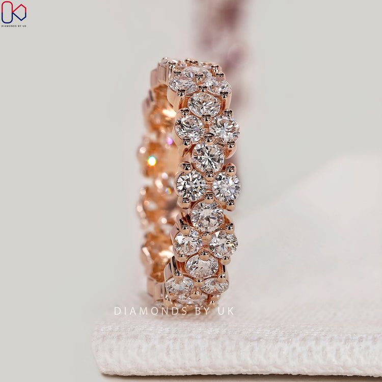 Round diamond eternity band with cluster setting.