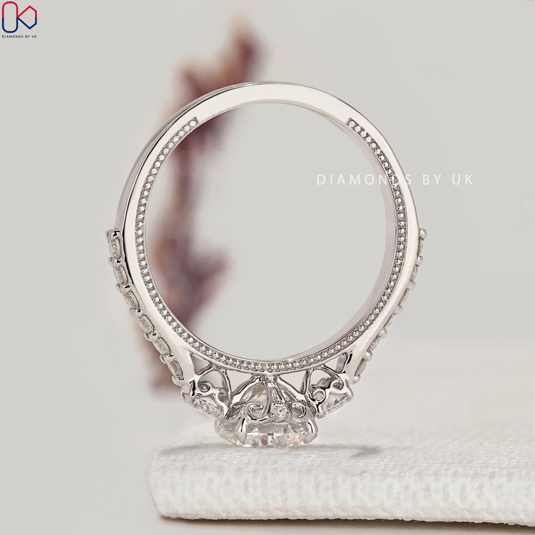 Round diamond ring with pavé and filigree setting.