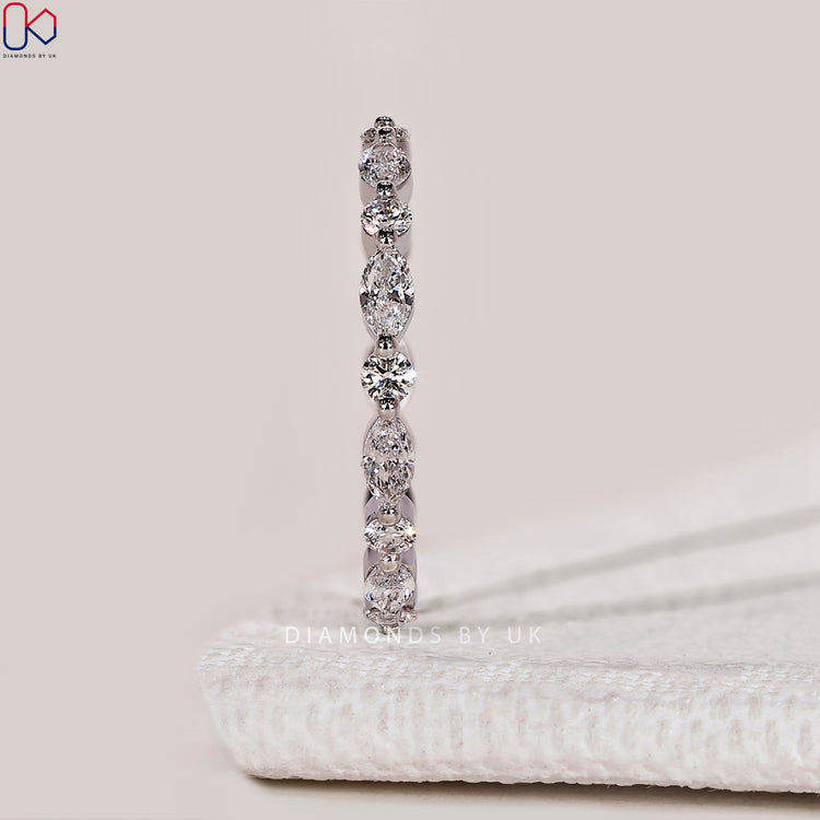 Full eternity band with marquise and round diamonds.
