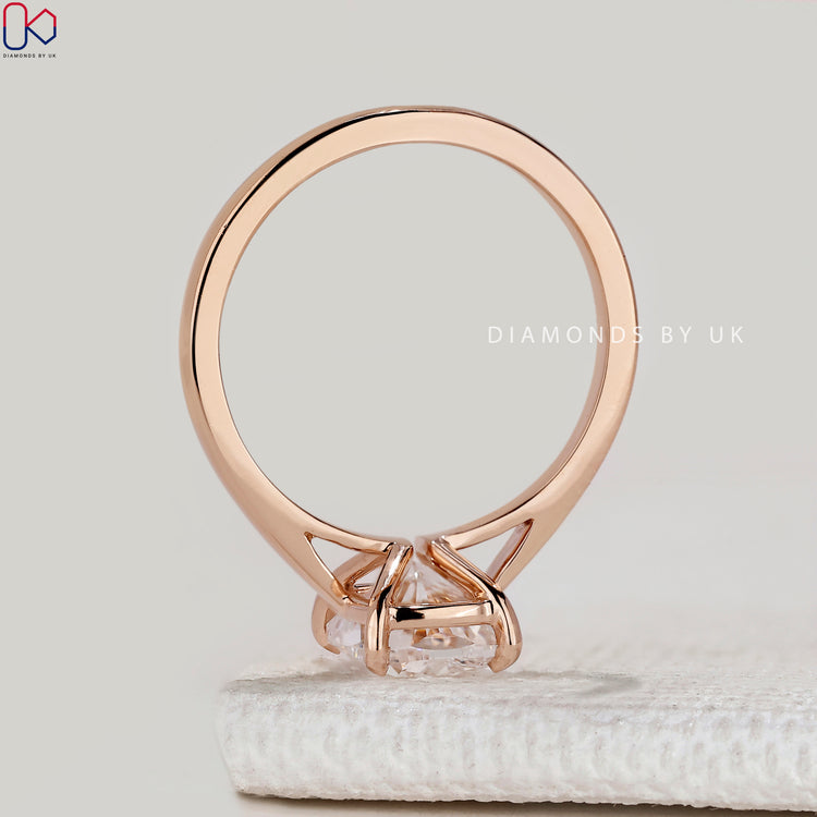 Cushion cut ring with cathedral and prong setting.