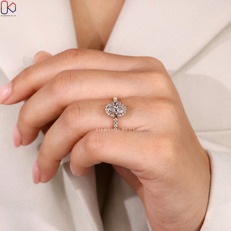 Lab grown oval ring with baguette and round halo.