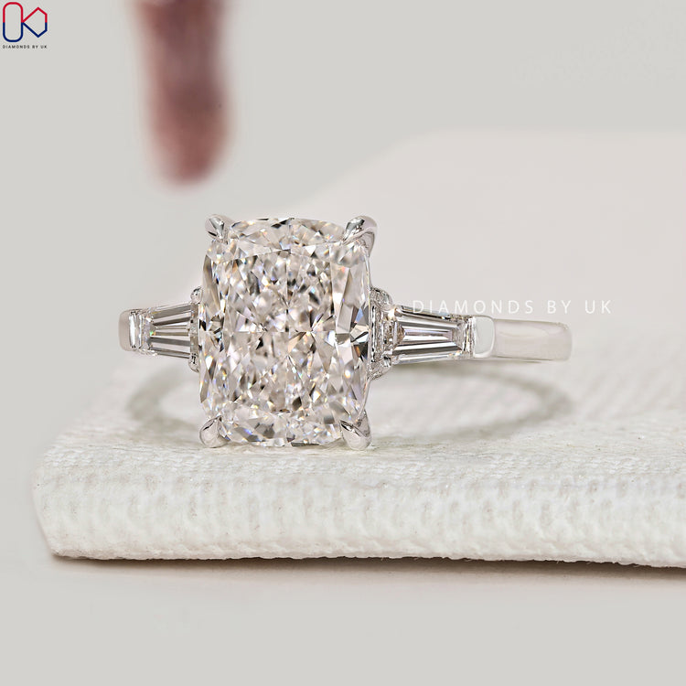 Lab grown cushion diamond ring with four claw prongs.
