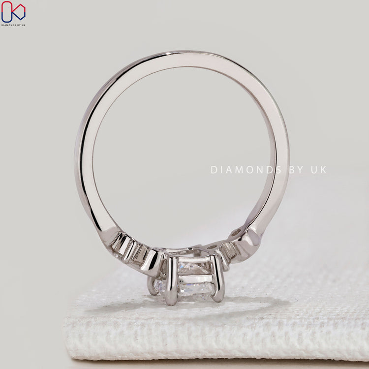 Cushion cut ring with five stone round diamonds.