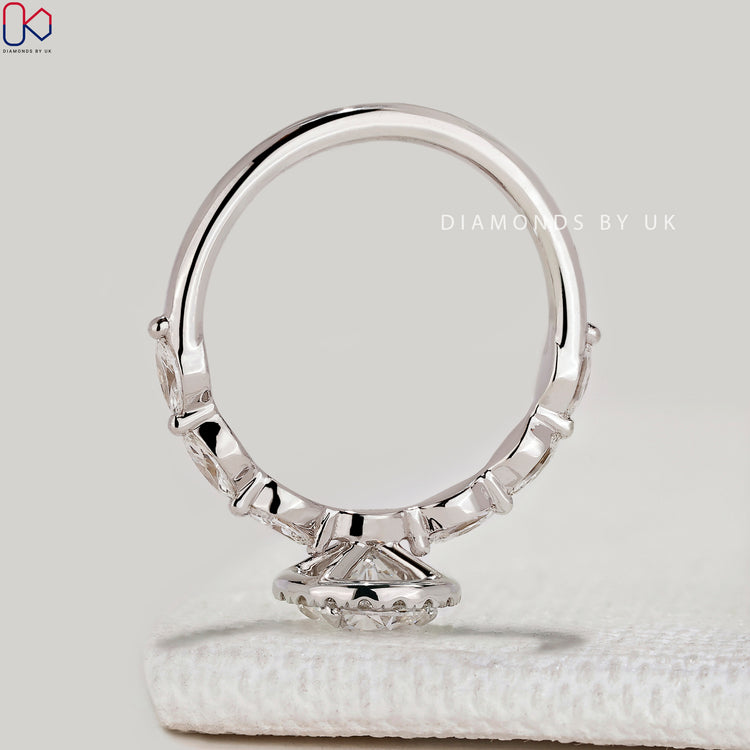 Round cut ring with marquise diamond pavé.