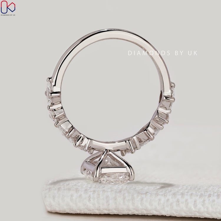 Radiant ring with marquise and round diamond pavé.