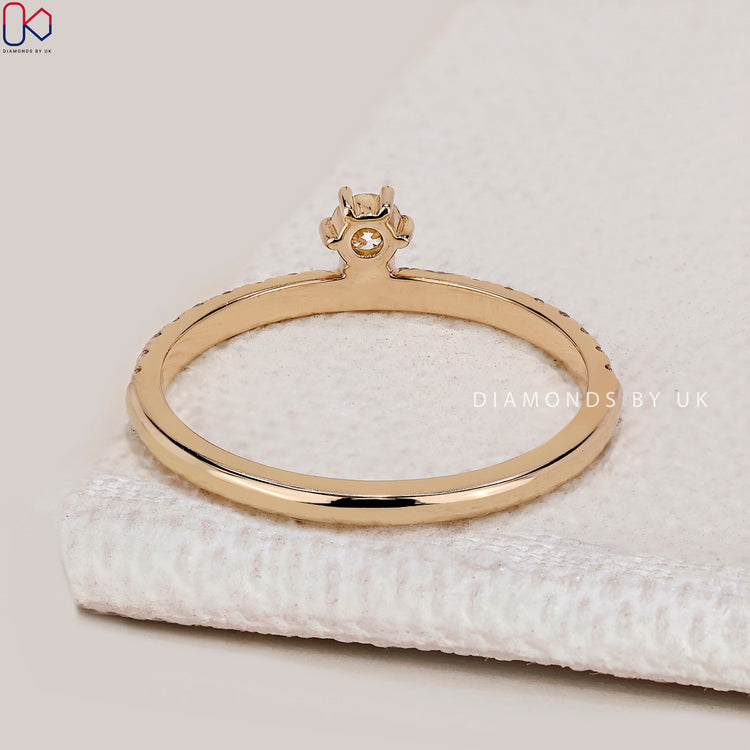 Round diamond band with six claw prong setting.
