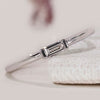 Baguette diamond band with a half bezel setting style.
