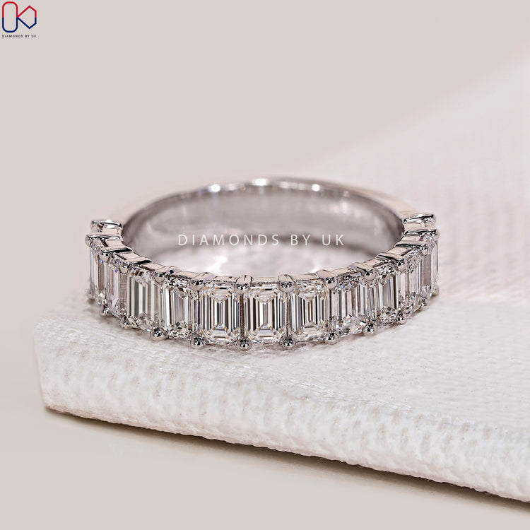 Emerald cut lab grown diamond band with prong setting.