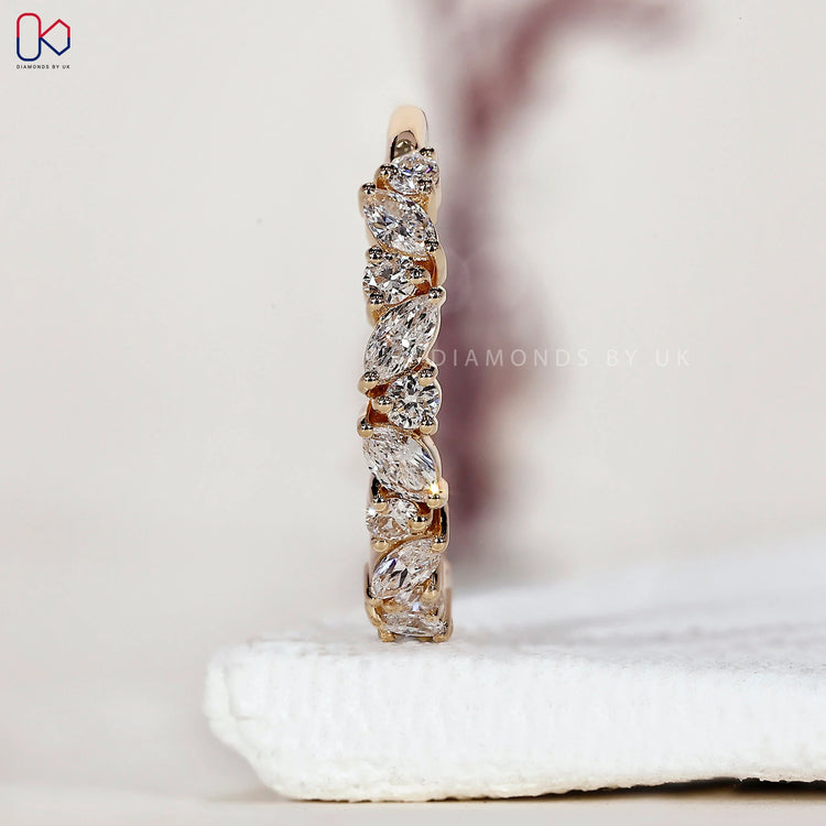 Marquise and round diamond wedding band crafted in a clean half eternity layout.
