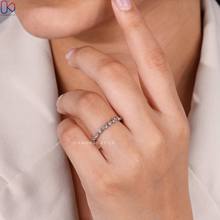 Marquise diamond band with round diamonds and shared prongs.