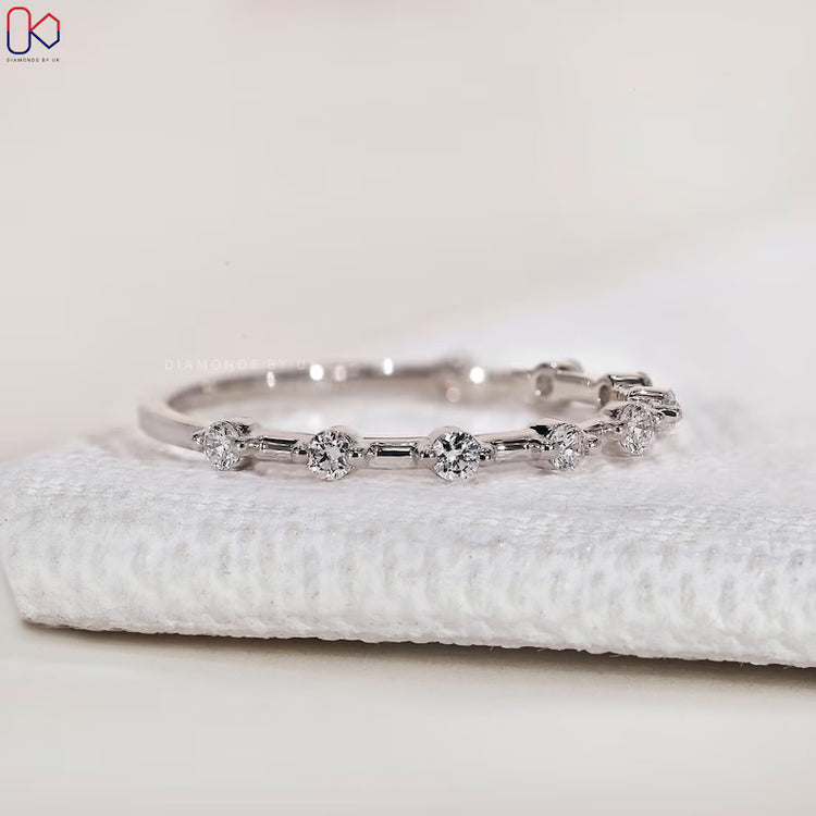 Round cut diamond band with distance pavé setting.
