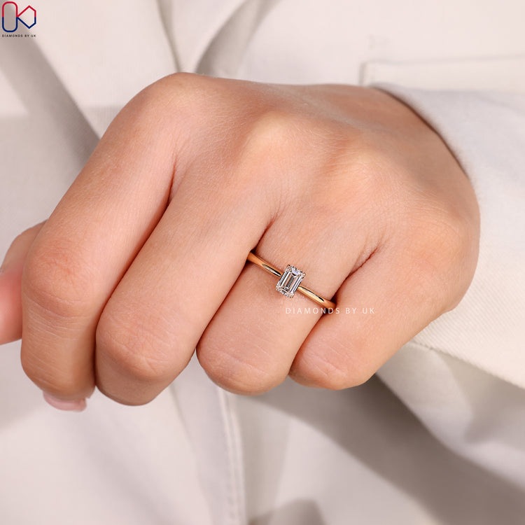 Four claw emerald diamond ring with tapered shank.