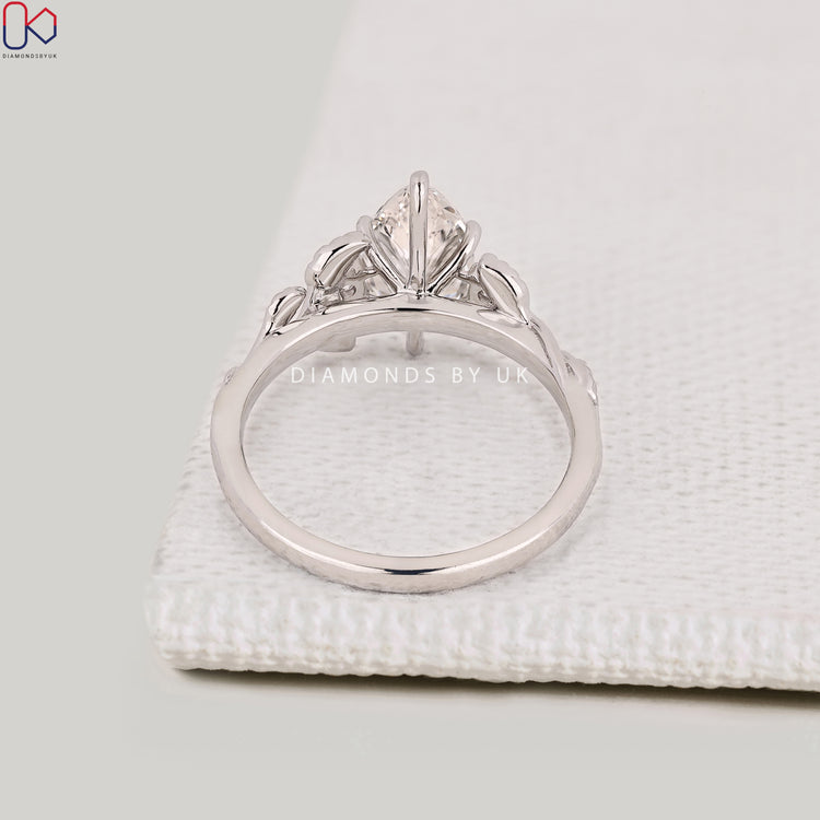 Handmade marquise cut diamond ring with round side stones.
