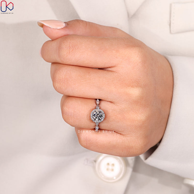 Halo round cut diamond ring with four claw setting.