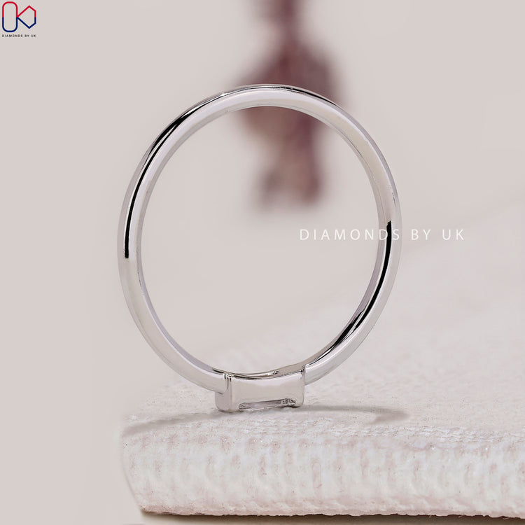 Baguette cut diamond wedding band with half bezel.
