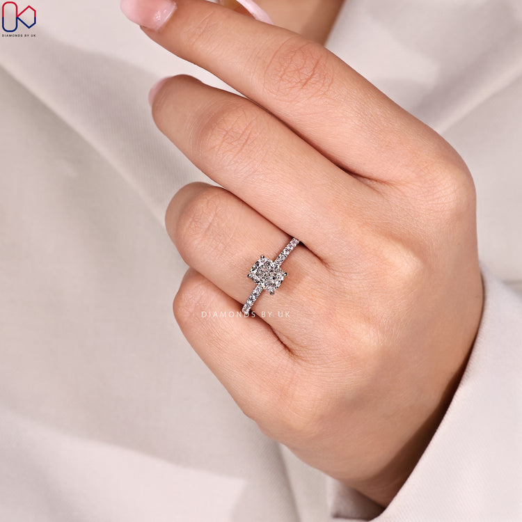 Cushion cut diamond ring with round pavé setting.