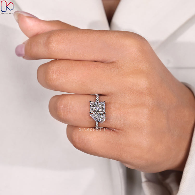 Radiant and pear ring with compass prong setting.